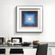 In a contemporary dining room, a table is elegantly set with white dishes, glasses, and black cutlery. Above it hangs the Viretta Blue Gradient Pyramid Textured 3D Wooden Wall Art by Giant Sculptures. Two black chairs complement this stylish setup.