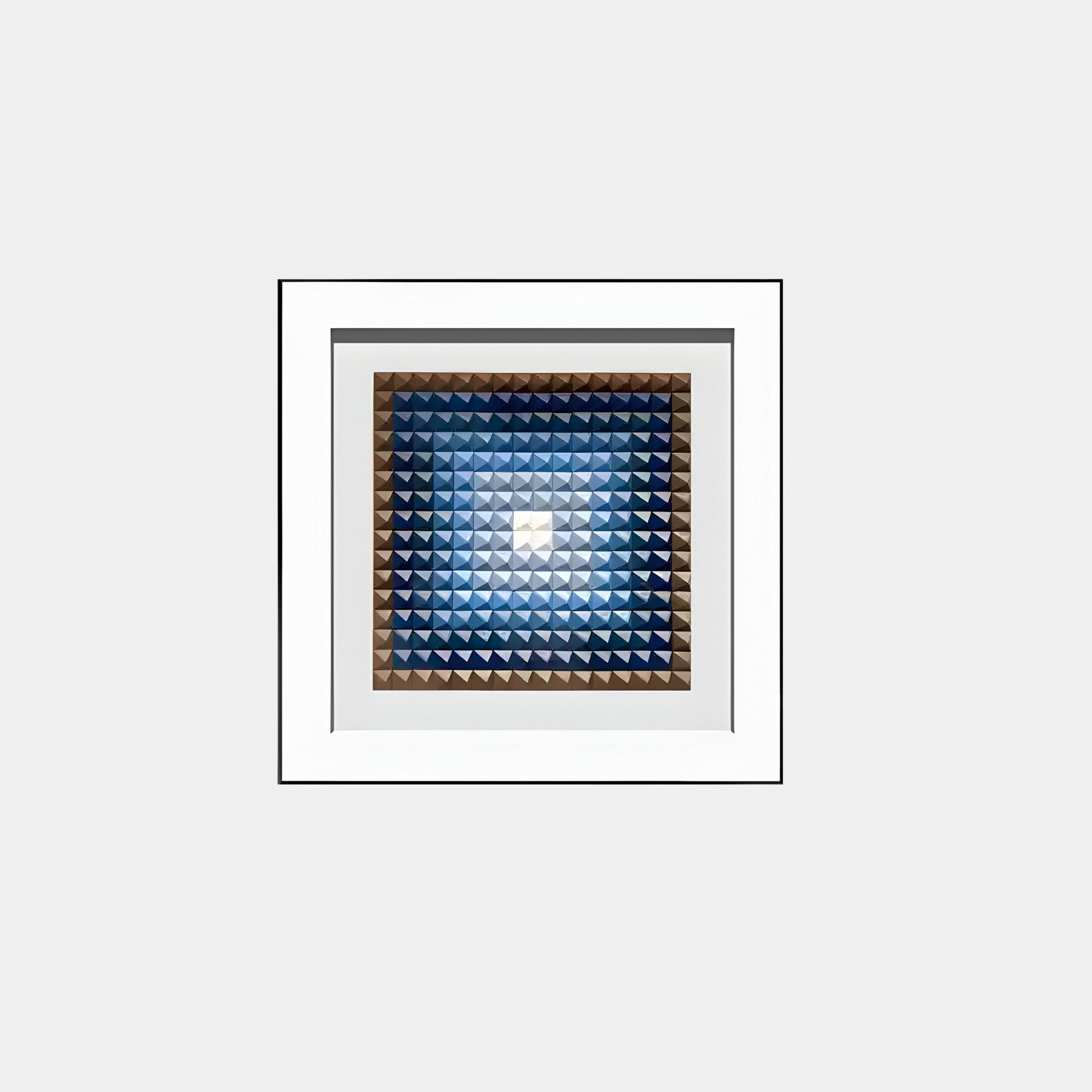 The Viretta Blue Gradient Pyramid Textured 3D Wooden Wall Art by Giant Sculptures features a modern design with small pyramid shapes in blue and beige, arranged in a square frame with a white border for an engaging visual effect.