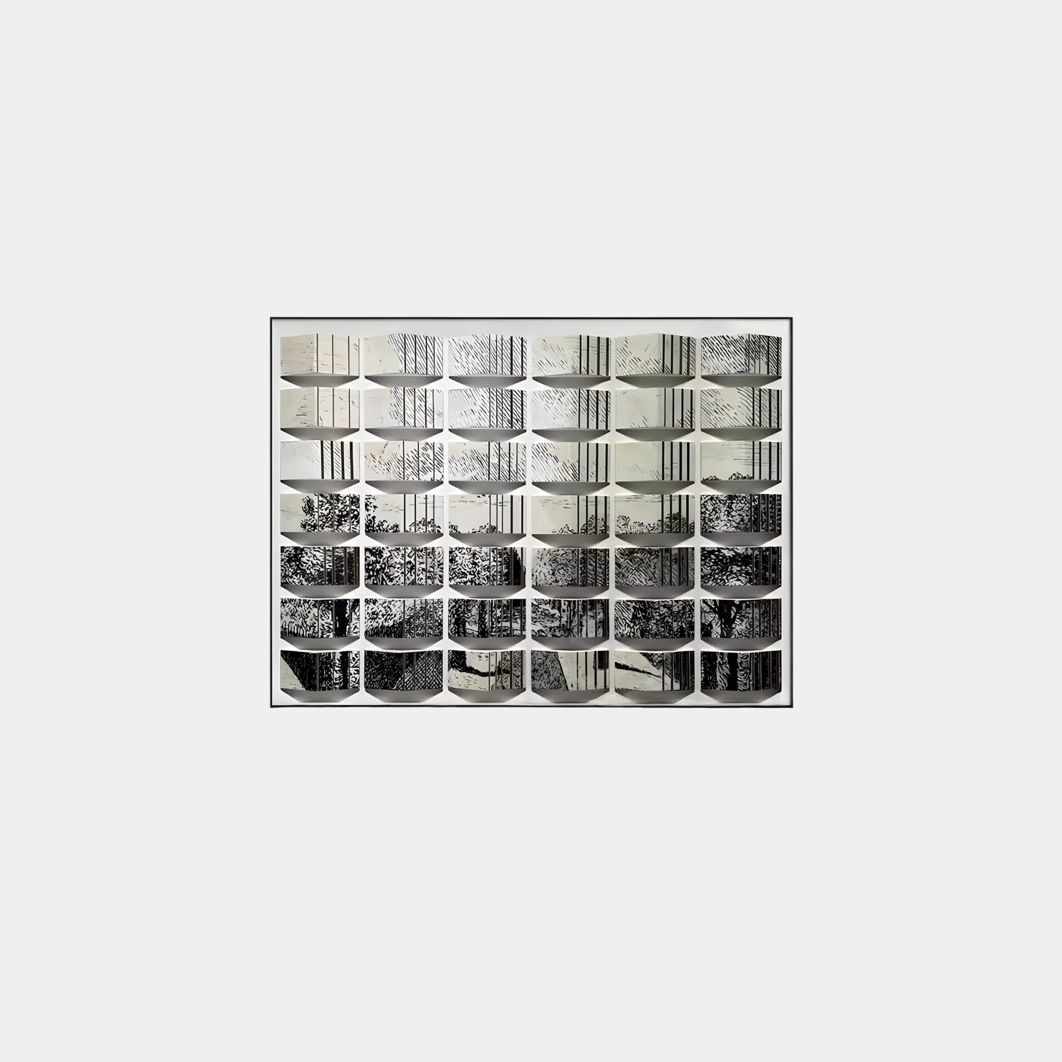 The Muraluxe Monochrome Landscape Curved Mosaic 3D Wooden Wall Art by Giant Sculptures features a grid of black-and-white tree branch photographs, creating a cohesive artwork with varying light and texture.