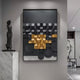 The space is adorned with Giant Sculptures Obscura Black & Gold Geometric 3D Wooden Wall Art, featuring stunning squares and circles. Nearby, a sculpture of a standing figure on a marble pedestal complements the decor, while a portrait against the wall subtly enhances the sleek modern interiors.