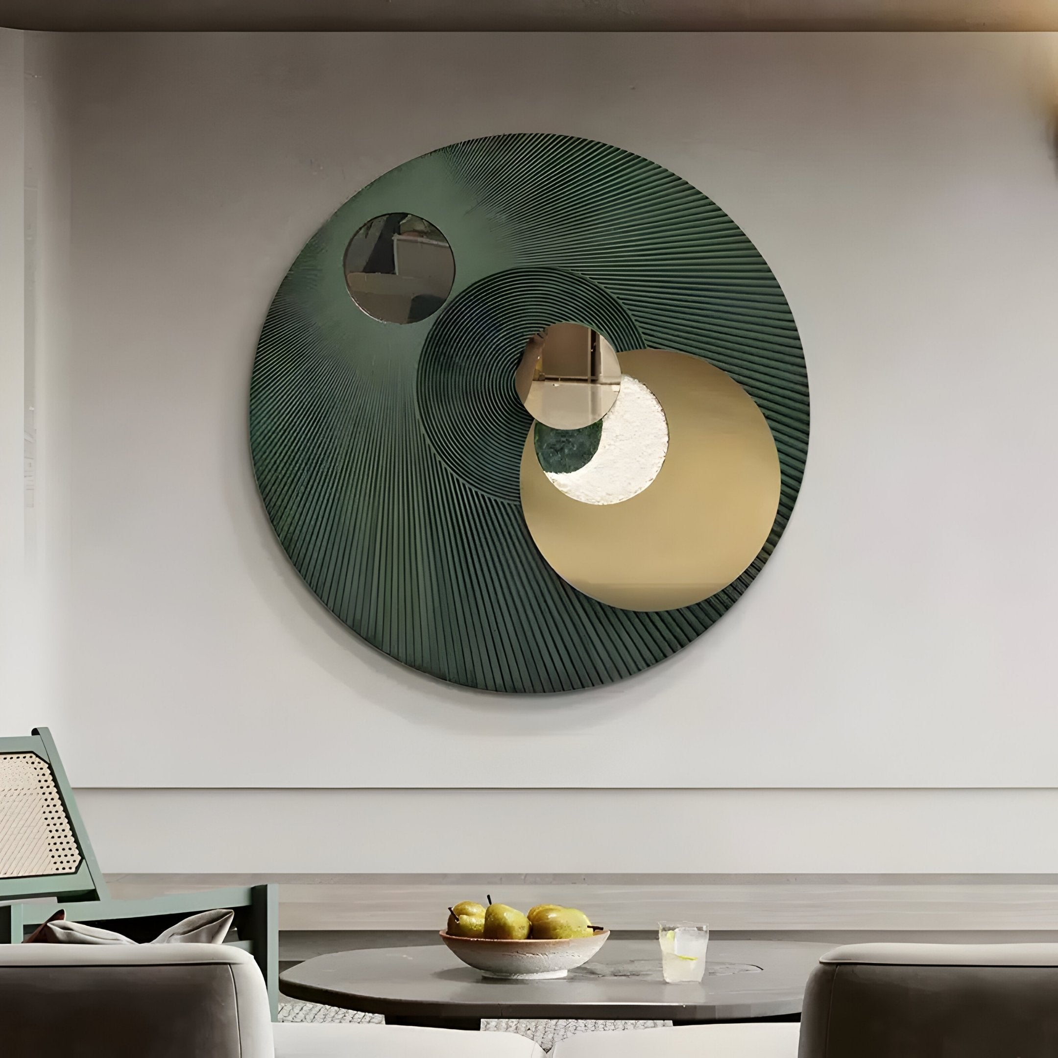 The Orbitra Green Reflective Circular 3D Wall Art by Giant Sculptures features an abstract green textured design with three overlapping mirrors. Below, a round wooden table displays apples and a drink, creating a cohesive decorative centerpiece.