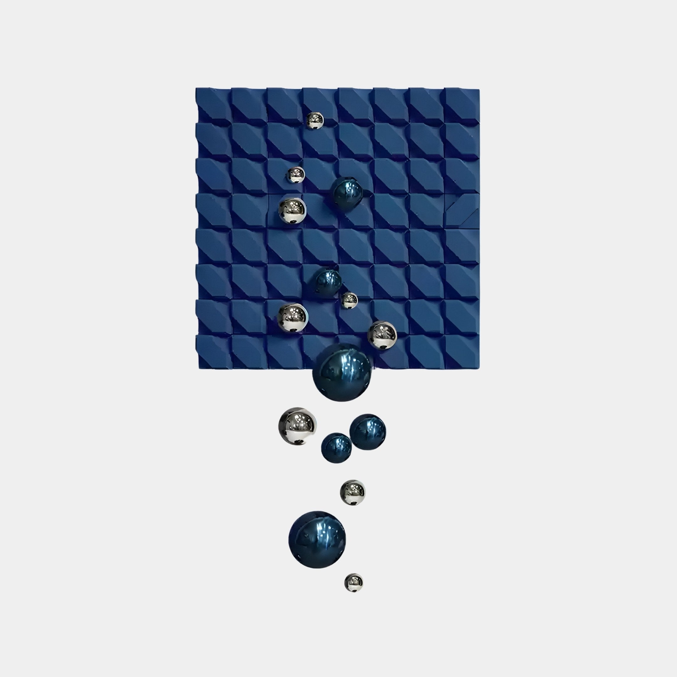 The Orbina Blue 3D Wood Relief Wall Art with Metal Ball by Giant Sculptures features a square of interlocking blue tiles with a textured pattern, adorned with shiny blue and silver spheres in varying sizes arranged diagonally for a dynamic, floating look ideal for contemporary interiors.