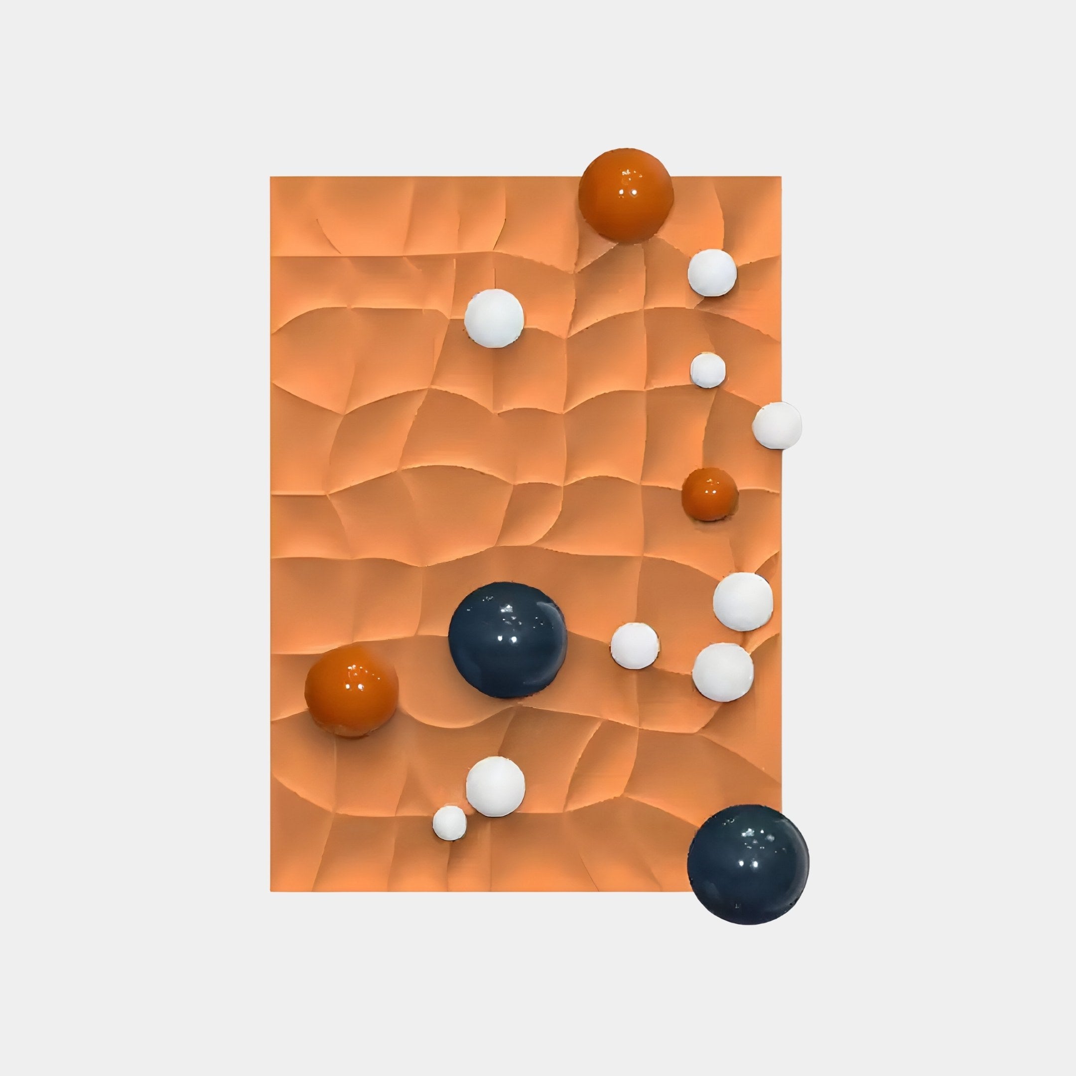 The Orbison Terracotta 3D Wood Relief Wall Art by Giant Sculptures showcases a captivating design of metal balls in orange, white, and dark blue on a woven terracotta background.