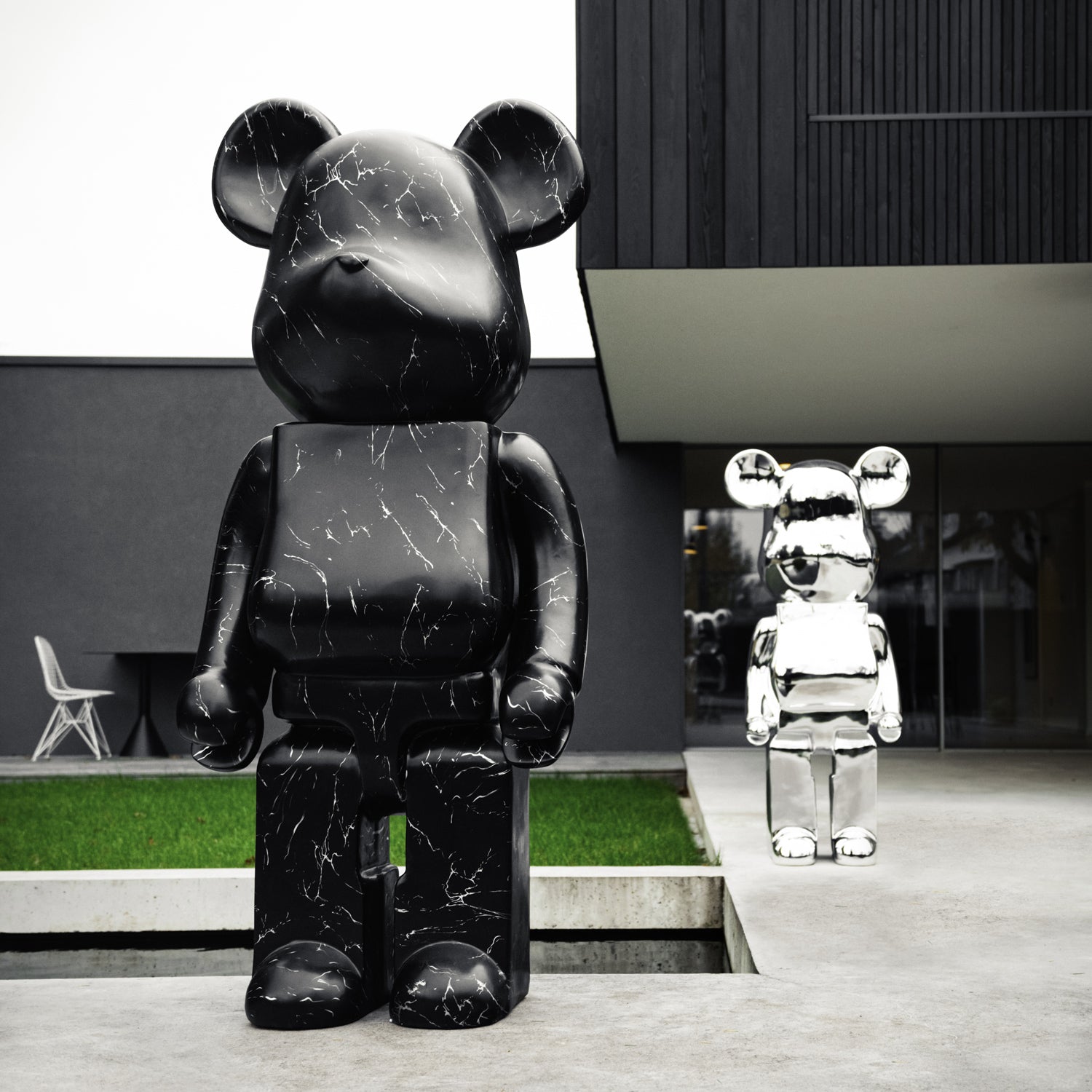 Giant Bears 165cm sculpture and chrome 135cm bear sculpture next to luxury modern home garden