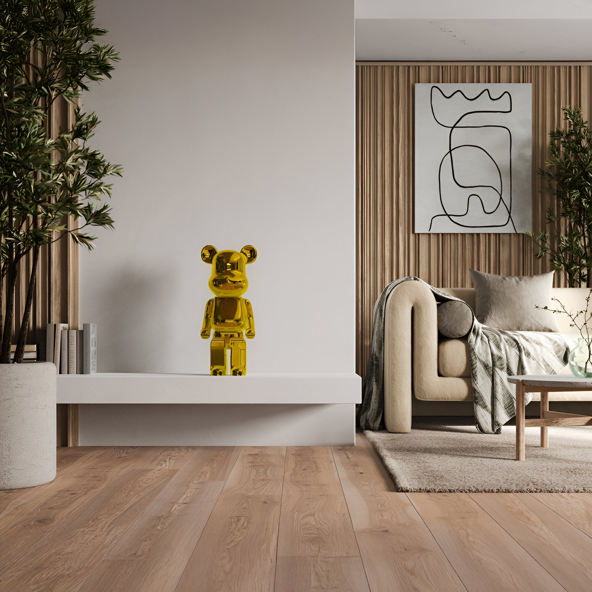 A contemporary living room features a polished wood floor, a white wall with a ledge displaying the 50cm Gilded Gold Bear Sculpture by Giant Sculptures. It also includes a beige sofa adorned with cushions, abstract wall art, and potted plants set against wooden paneling.